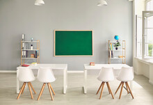 Empty School Classroom Interior With Desks And Chairs, Space For Text On Chalkboard. Modern Schoolroom With Furniture