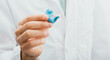 © Peakstock - Doctor holding in his hands molded individual hearing aid earmolds for his patient, close-up. Hearing solution
