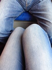 Wall Mural - Vertical shot of a male and a female legs wearing tight jeans