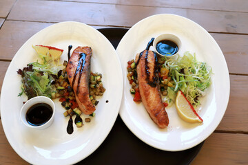 Two plates with grilled salmon