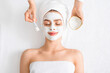 © Prostock-studio - Spa therapist putting facial mask for young lady
