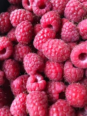 Delicious ripe raspberries on the table macro