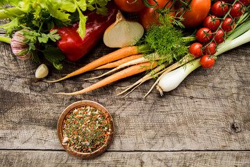 Wall Mural - Plate with spice mix and fresh vegetables, ingredients for seasoning