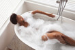 Woman relaxing in a bathtub