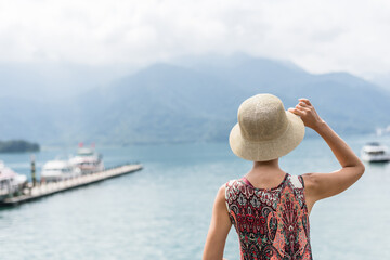 Wall Mural - traveling Asian woman with hat