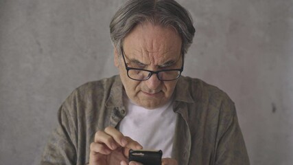 Wall Mural - senior man using the mobile phone
