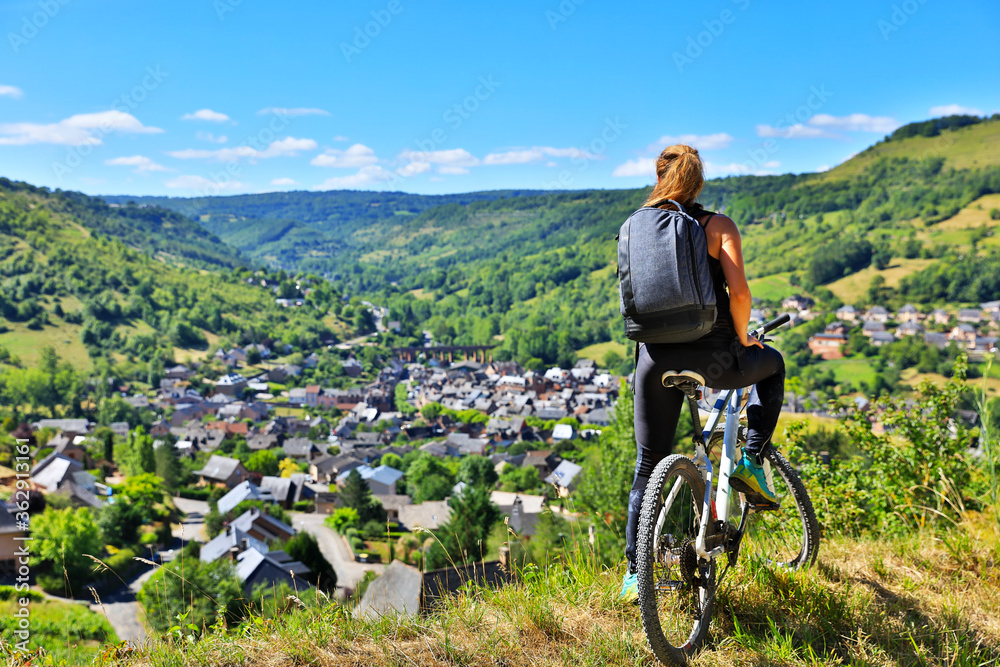 active woman biking countryside- Aveyron in France - obrazy, fototapety, plakaty 