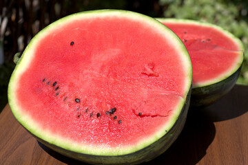 Fresh ripe sliced watermelon , on wooden background