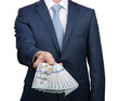 © Alekss - Businessman holding money cash in hands of passing them to the client.