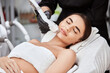 beautiful woman in spa salon receiving laser depilation theraphy for her chin