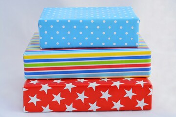 Poster - Isolated closeup shot of colorful gift boxes stacked on top of each other on a white background