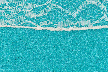 Wall Mural - Delicate lace textured material on teal paper background