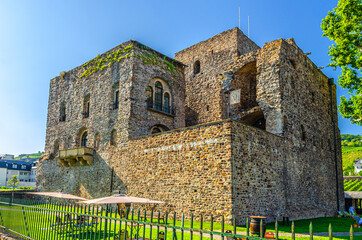 Bromserburg medieval stone lowland castle building in Rudesheim am Rhein historical town centre, blue sky background, State of Hesse, Germany