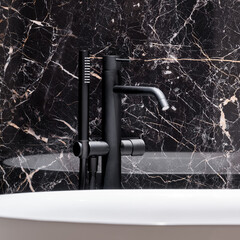 Wall Mural - close-up on black bathtub faucet