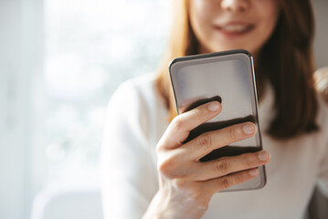 Woman hand holding mobile phone, She using in mobile applications and multimedia programs. copy space