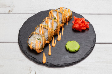 baked roll with sauce on a black slate