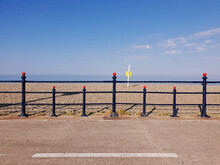 The Bray Seafront With Horizon And The Irish Sea Visible Across The Barrier. Seascape. Sunny Day. Geometry And Visual Symmetry.