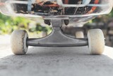 Closeup of a skateboard on the ground under the sunlight with a blurry background