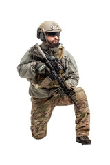 Wall Mural - American soldier in military equipment with a rifle attacks on a white background, a commando with weapons in uniform, a ranger in action