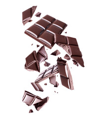 Wall Mural - Bar of dark chocolate crushed in the air on a white background