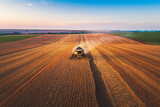 Fototapeta  - Combine harvester agriculture machine harvesting golden ripe wheat field