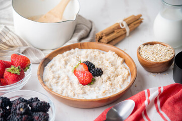 Poster - oatmeal with berries in wood bowl