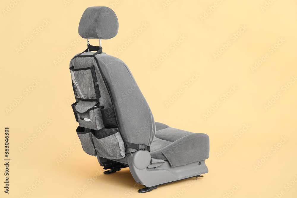 Travel organizer on car seat against color background
