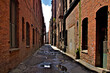 Old brick buildings and travel-worn brick alleyway from bygone era, Old Industrial District, Seattle, Washington