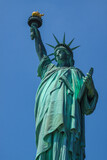 Fototapeta Nowy Jork - Close shot of Statue of Liberty in New York City, with blue sky.
