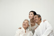 © ImageHit - Woman and senior couple smiling while looking away