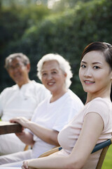 Wall Mural - Woman with senior couple in the park