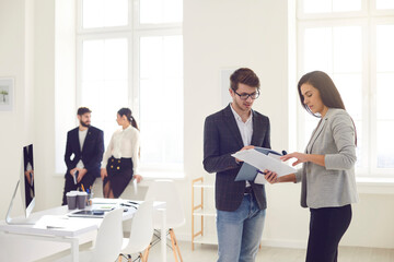 Business people busy discussing analyze project risks at workplace in modern white office.