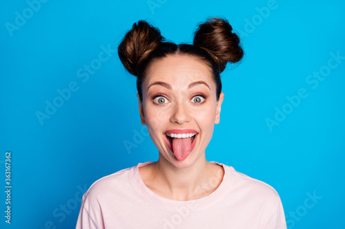 Fotografía Closeup photo of attractive childish lady two funny buns sticking tongue out mou