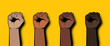 Pop art raised clenched fists on yellow background.