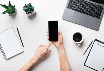 Aufkleber - Woman hands using cellphone in office, top view, blank screen