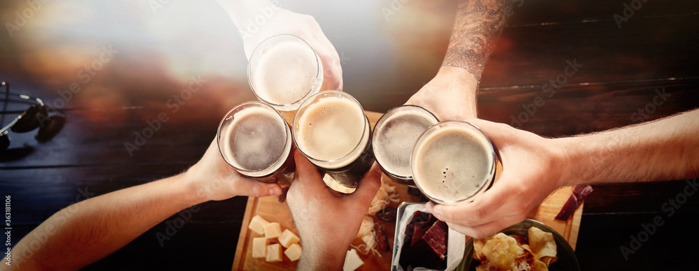 Group of friends toasting with beer in pub, top view. Banner design - obrazy, fototapety, plakaty 