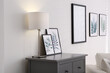 Modern room interior with grey chest of drawers