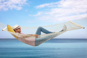 Sticker - Man resting in hammock near sea on sunny day