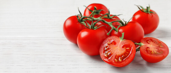 Fresh cherry tomatoes on white wooden table, space for text. Banner design