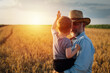 © cherryandbees - farmer and his grandson walking fields of wheat