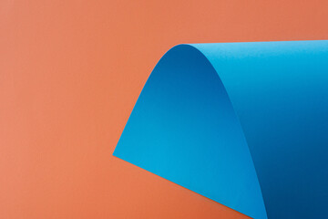 Sticker - blue colorful paper swirl on orange background