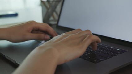 Fototapete - close-up of woman hands typing on laptop keyboard on the table.