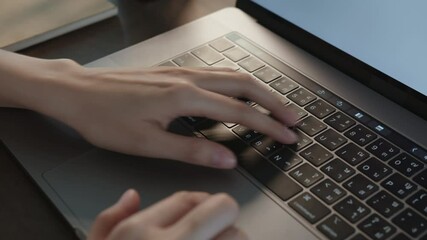 Fototapete - close-up of woman hands typing on laptop keyboard on the table.