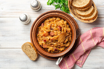 Wall Mural - Traditional Polish dish Bigos in ceramic bowl on rustic wooden table