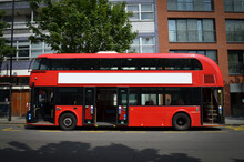 A Modern London Double-decker Bus, Spotted From The Left Side, With Its Doors Open.
