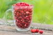 Wild strawberries in a glass cup