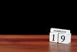 © Sapiens - 19 March calendar month. 19 days of the month. Reflected calendar on wooden floor with black background