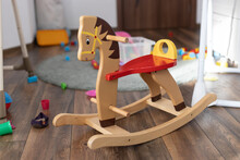 Wooden Rocking Horse. Children Toy In Messy Children's Room