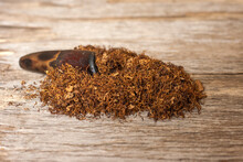 Tobacco And Smoking Pipe On A Wooden Background