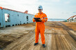 © Igor Kardasov - Filipino deck Officer on deck of offshore vessel or ship , wearing PPE personal protective equipment. He fills checklist. Paperwork at sea